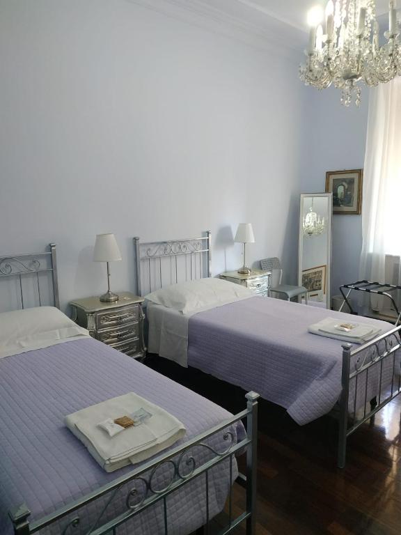A bed or beds in a room at Around The Corner Colosseo B&B