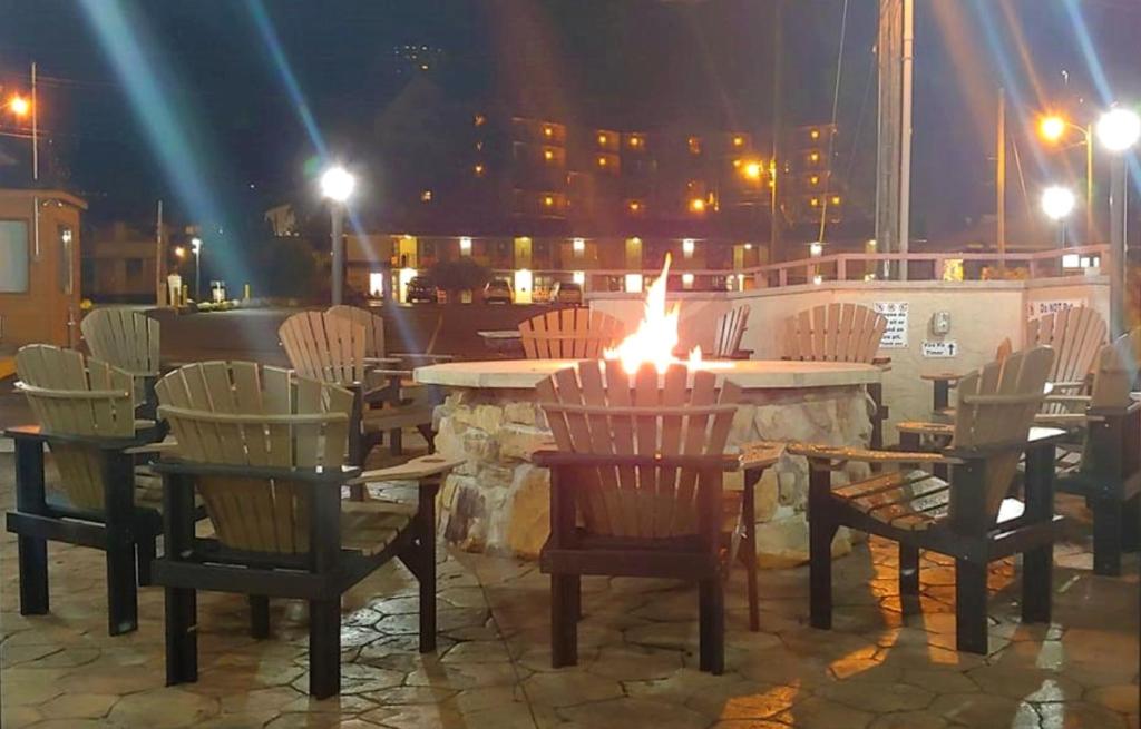 a table and chairs with a lit candle on top at Howard Johnson by Wyndham Downtown Gatlinburg in Gatlinburg