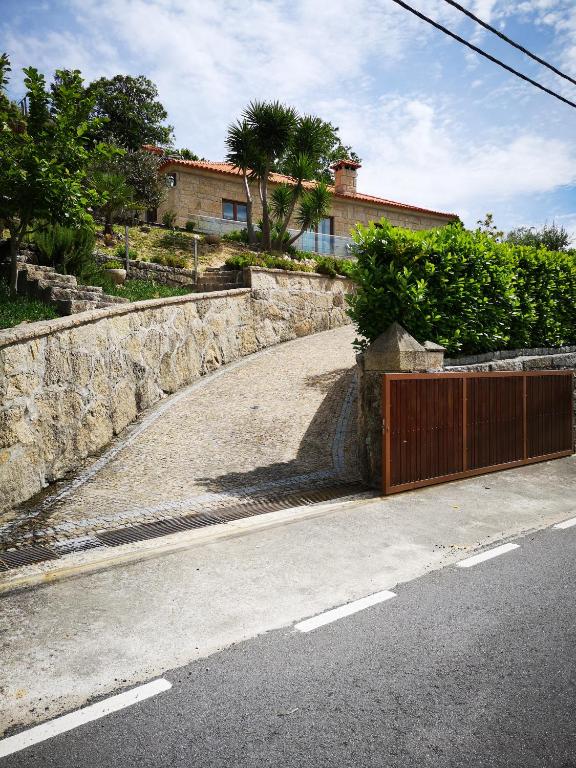 a road with a gate on the side of a house at Encosta do Douro - Rio Douro in Cinfães