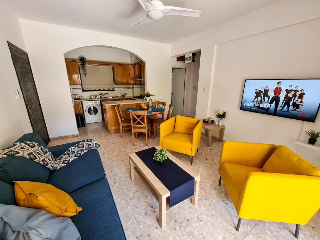 a living room with two couches and a kitchen at The Perfect Vacation Place in Paphos City