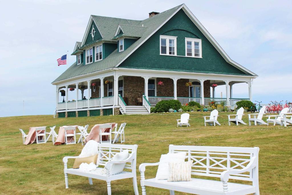 uma casa com cadeiras brancas em frente em The Sullivan House em New Shoreham