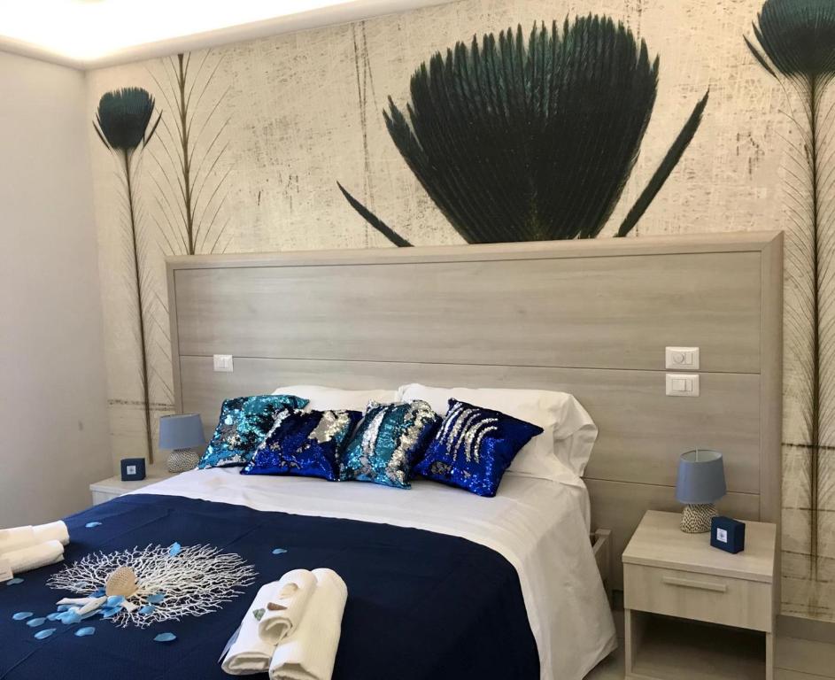 Postel nebo postele na pokoji v ubytování Il corallo azzurro