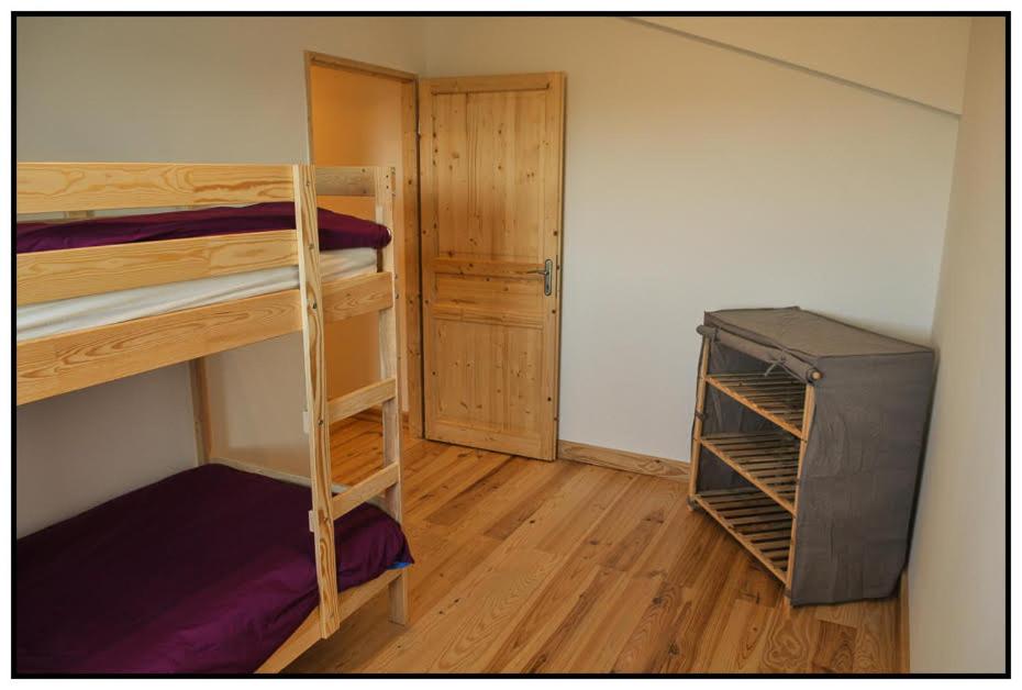 a room with two bunk beds and a refrigerator at Gîte du Mas Saint-Victor in Bonnieux