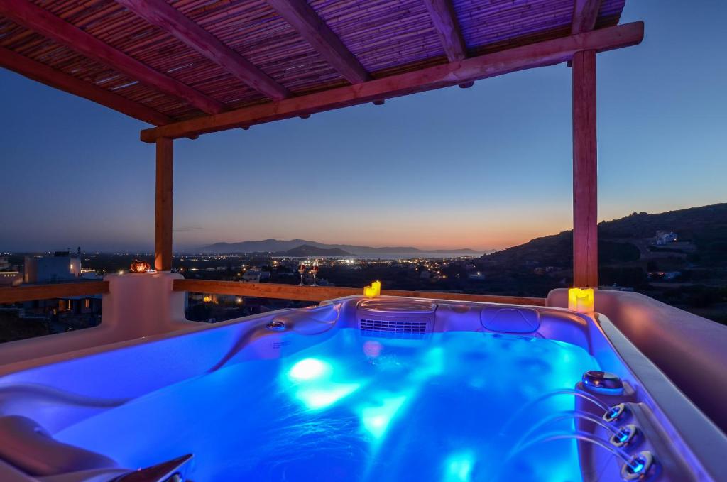 a jacuzzi tub on the roof of a house at Naxos Pantheon Luxury Apartments in Agkidia