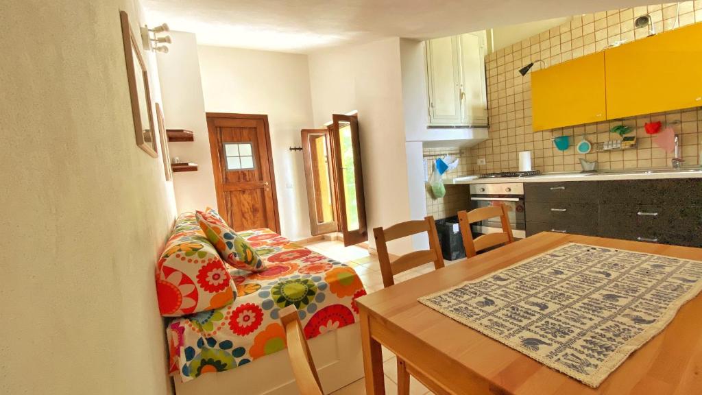 a kitchen and dining room with a table and a couch at Casa Santicelli Maratea “ Il Campanile” in Maratea