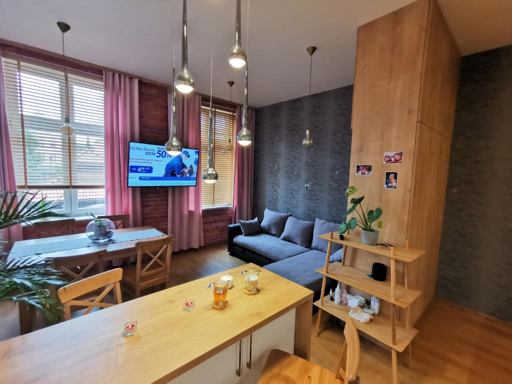 a living room with a couch and a table at Apartament Słoneczny na Placu Wejhera in Wejherowo