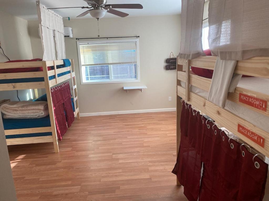 a room with several bunk beds and a window at WHOLE Family - Barrette in Sacramento