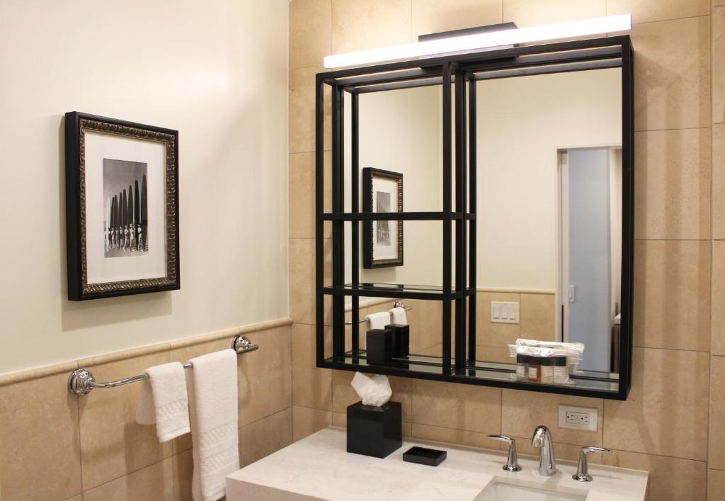 a bathroom with a sink and a mirror at La Valencia Hotel in San Diego