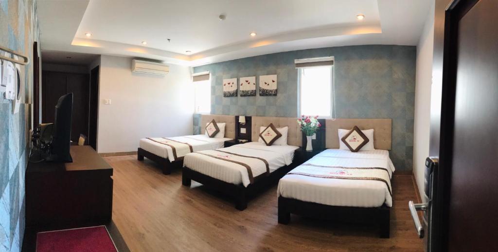 Postel nebo postele na pokoji v ubytování Hoang Sa Hotel