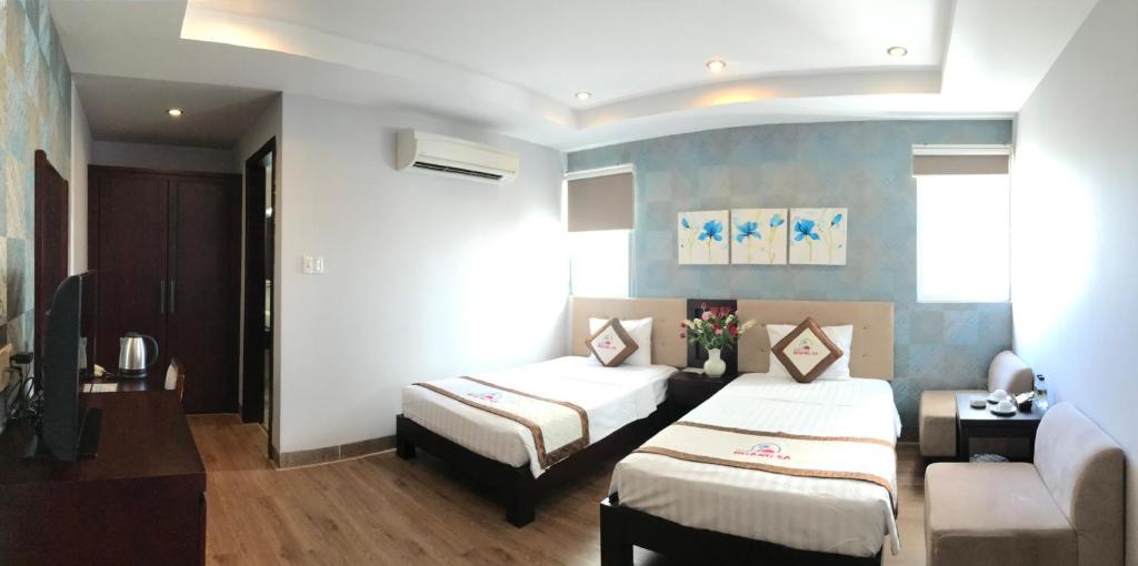 Postel nebo postele na pokoji v ubytování Hoang Sa Hotel