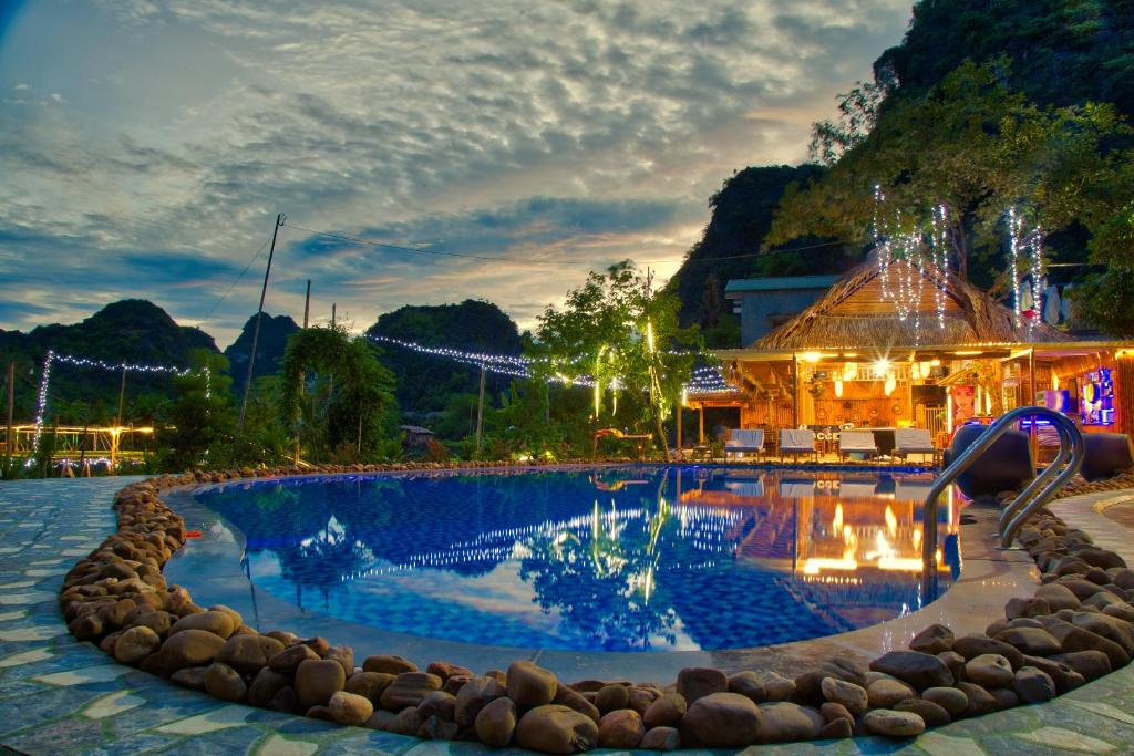 a swimming pool at a resort at night at Green Mountain Homestay in Ninh Binh