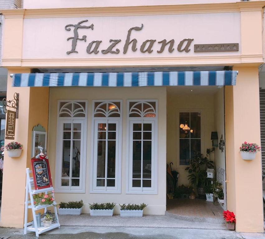 a restaurant with a sign on the front of it at Fazhana Village B&B in Hualien City