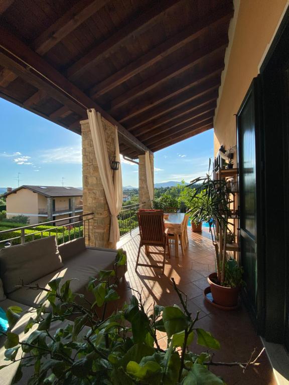d'une terrasse avec une table et des chaises sur un balcon. dans l'établissement Appartamento Nel verde del Parco della Rocca, à Manerba del Garda