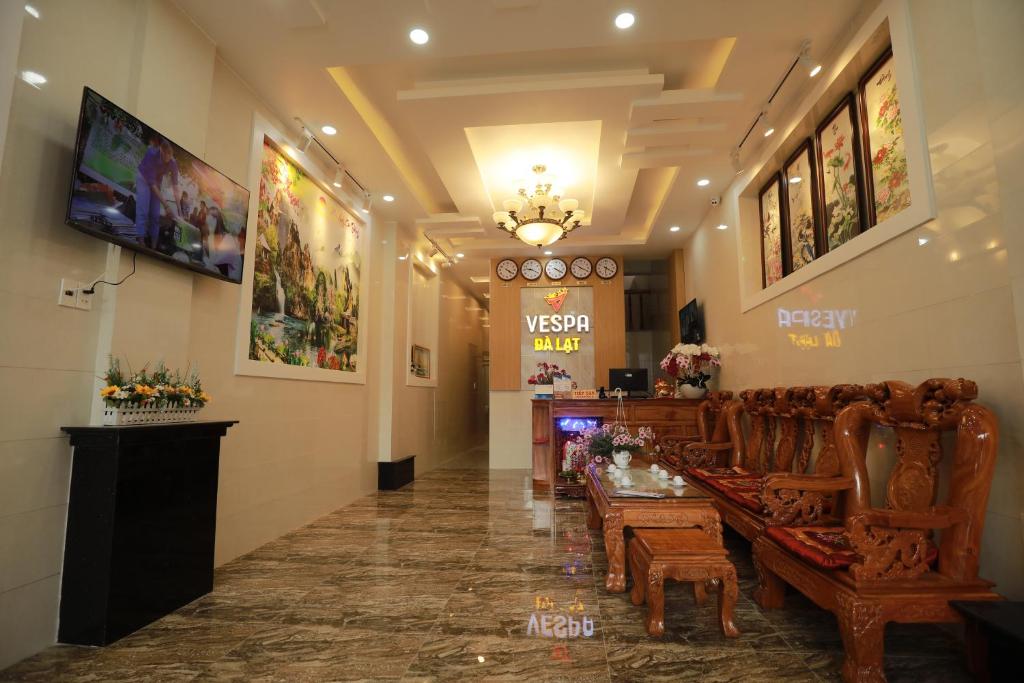 a lobby with a waiting room with chairs and a bar at VES - PA Luxury Hotel in Da Lat