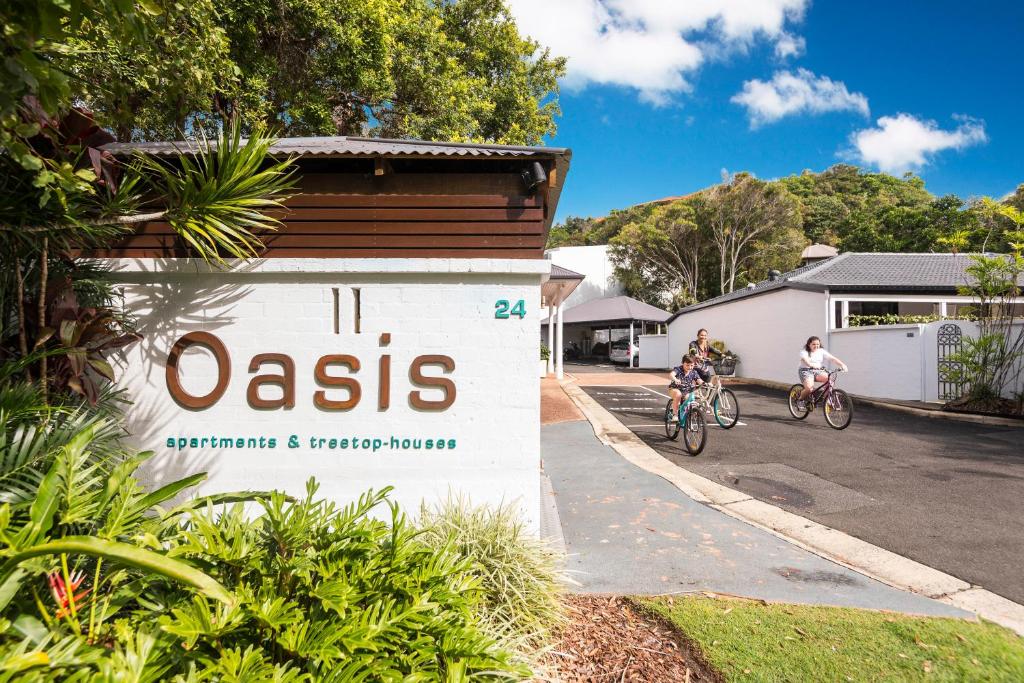a bicycle is parked on the side of the road at The Oasis Apartments and Treetop Houses in Byron Bay