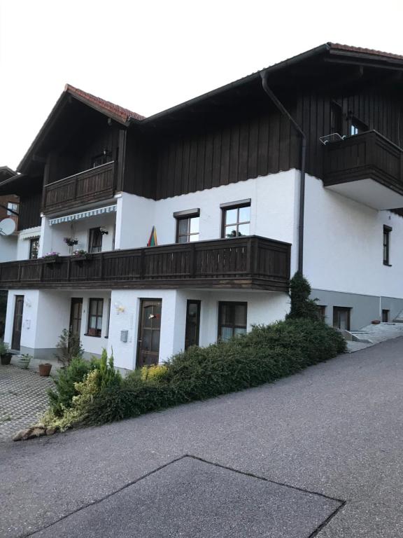 a white building with balconies on top of it at Ferienwohnung Magdalena in Bodenmais