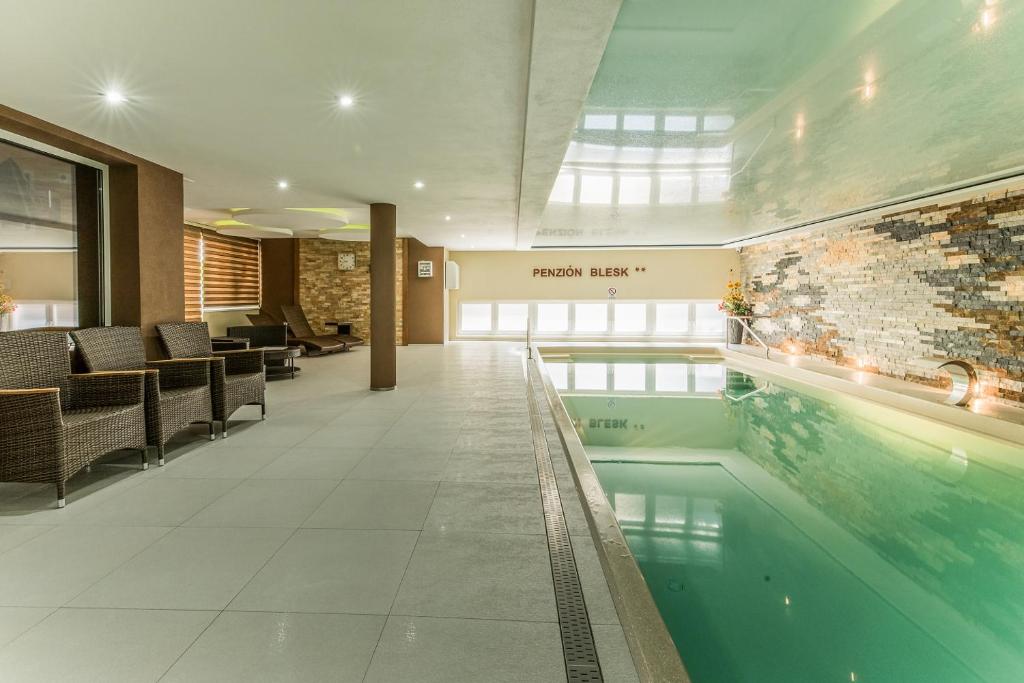 a lobby with a swimming pool in a building at Penzion Blesk in Ružomberok