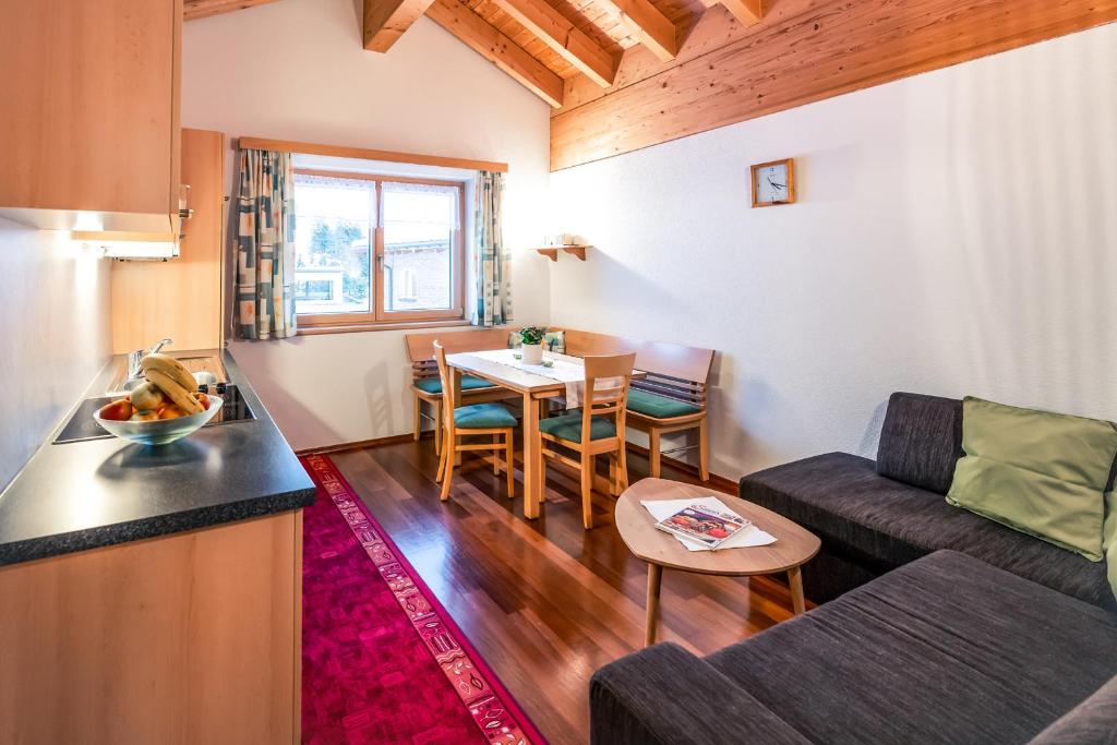 a living room with a couch and a table at Haus Rothorn in Schröcken