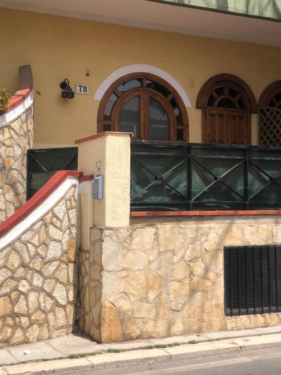 a building with a window and a stone wall at Casetta Mondello in Mondello