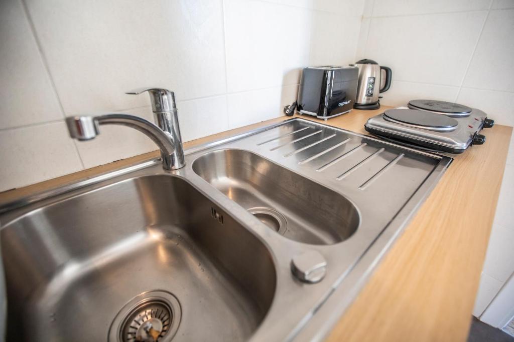 a stainless steel sink in a small kitchen at ++++ renovated cosy 50m2 sunny flat &#47; balcony &#47; close to beach and to the Palais des festivals ++++ in Cannes