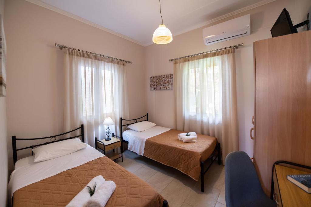 Postel nebo postele na pokoji v ubytování Villa Nektaria