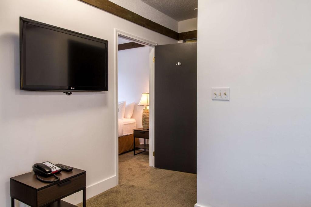 a room with a flat screen tv on a wall at Stoke Hotel SureStay Collection by Best Western in Revelstoke