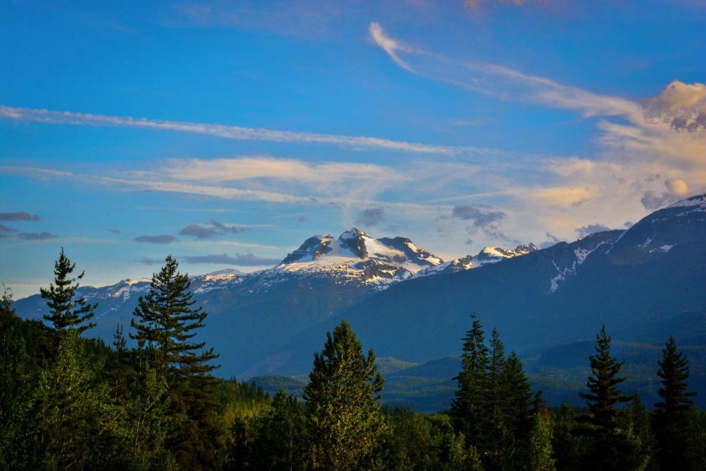 a view of a mountain range with trees in the foreground at Stoke Hotel SureStay Collection by Best Western in Revelstoke