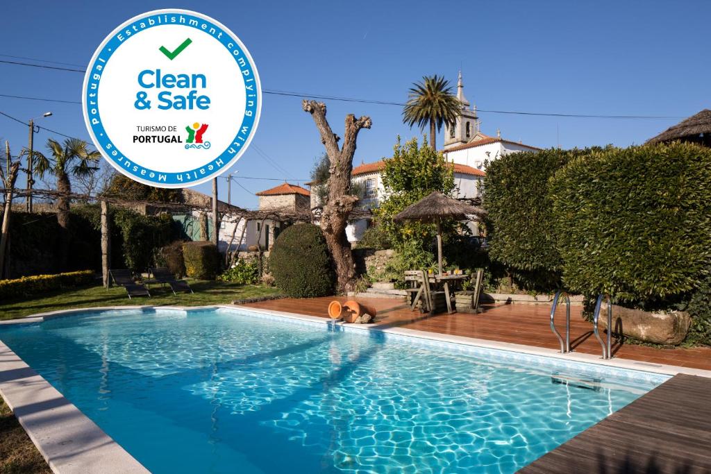 a swimming pool with a sign that says clean and safe at Quinta Sao Miguel de Arcos in Vila do Conde