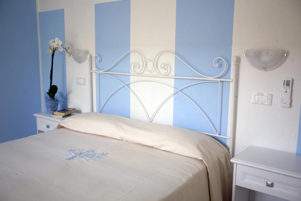 Postel nebo postele na pokoji v ubytování Hotel Stella D'Oro