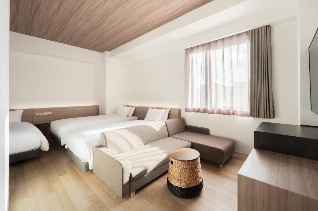 Postel nebo postele na pokoji v ubytování Nest Hotel Hiroshima Ekimae