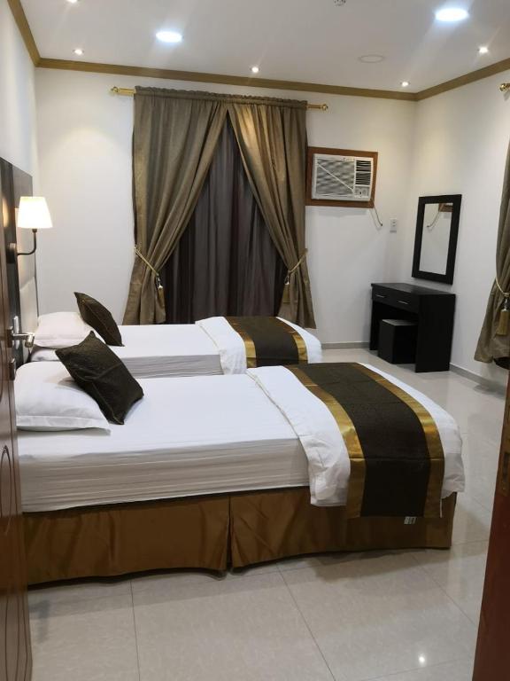 Postel nebo postele na pokoji v ubytování روح الأصيلة للشقق المخدومة Roh Alaseilah Serviced Apartments