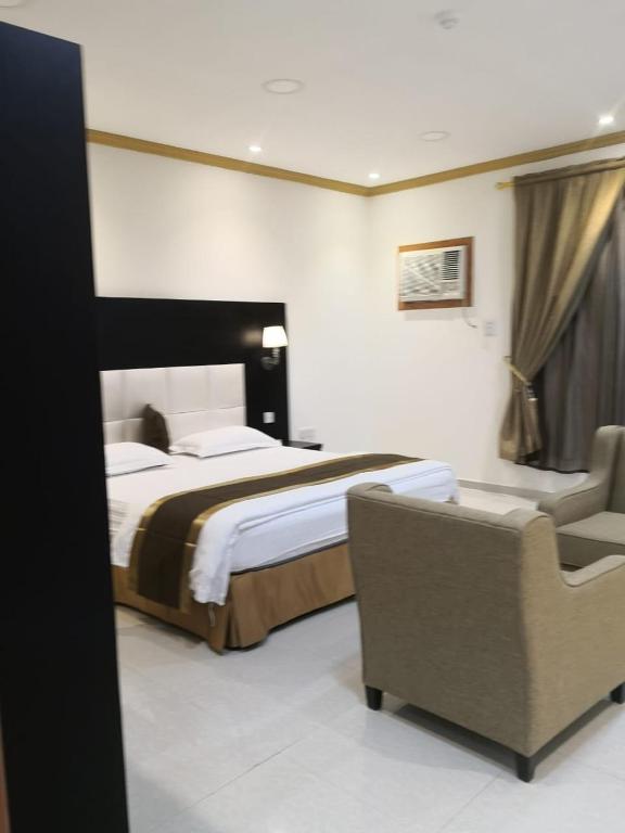 Postel nebo postele na pokoji v ubytování روح الأصيلة للشقق المخدومة Roh Alaseilah Serviced Apartments