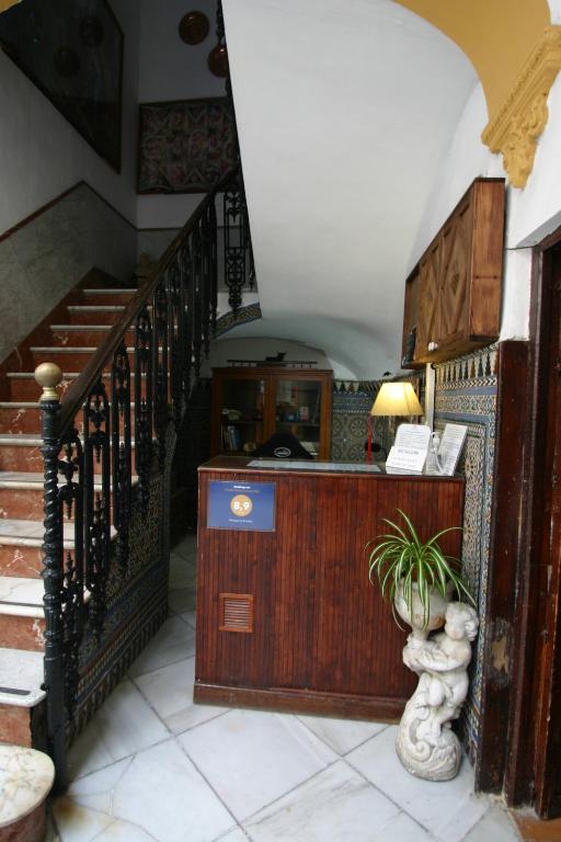 a large room with stairs leading to a staircase at Pension el Portillo in Córdoba