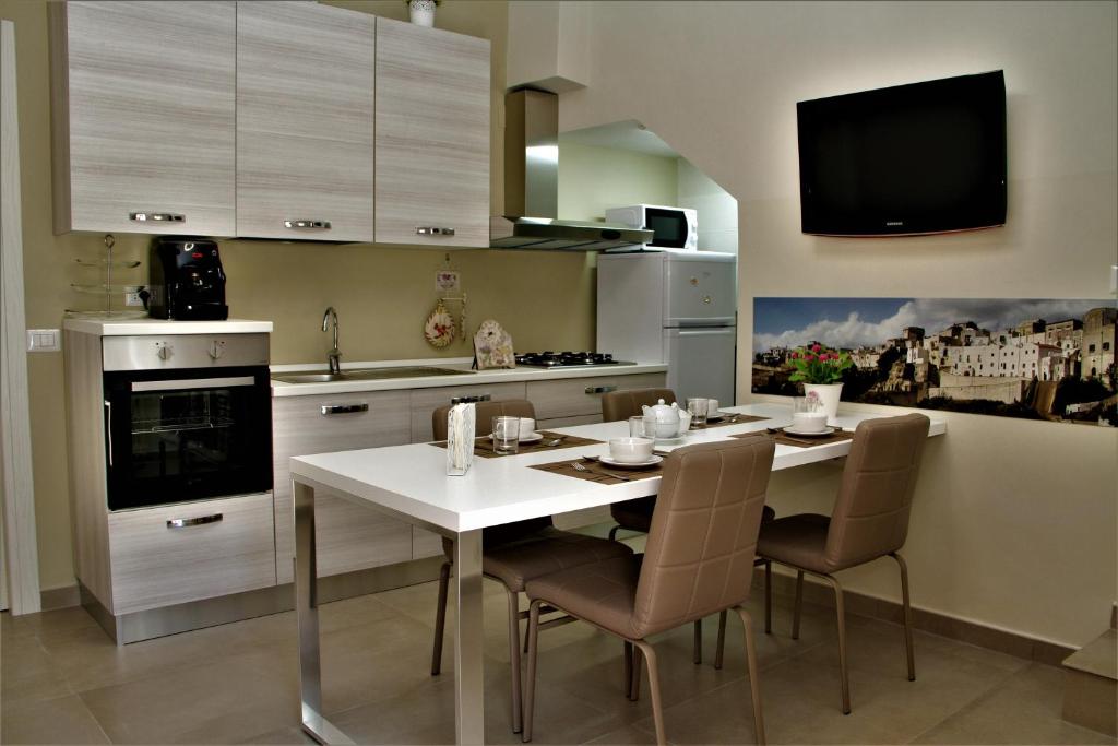 モンテスカリオーゾにあるCasa Vacanze Civico 32のキッチン(白いテーブル、椅子付)