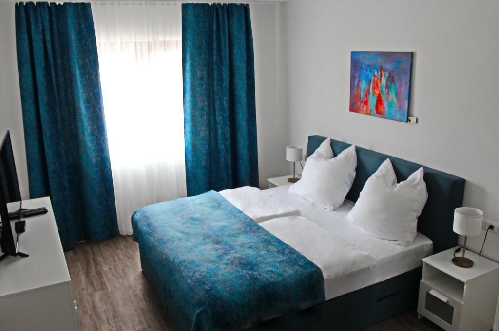 Postel nebo postele na pokoji v ubytování Catalleya Haus