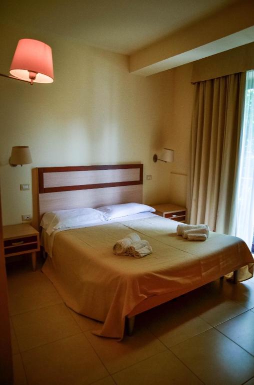 Postel nebo postele na pokoji v ubytování Hotel Milomax