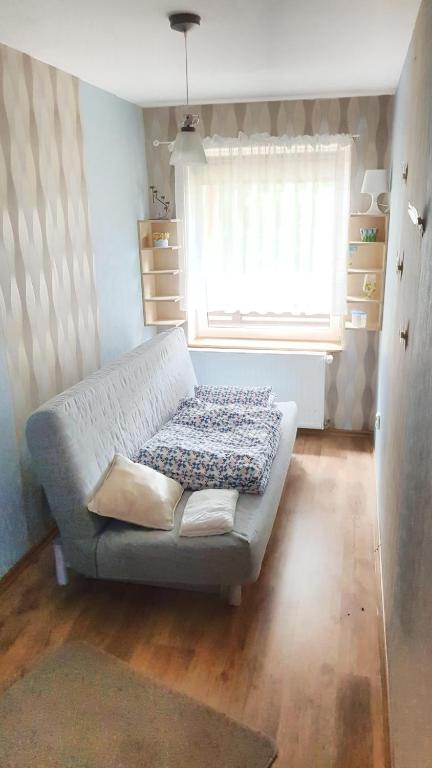 a living room with a couch and a window at Studio Ania in Stegna