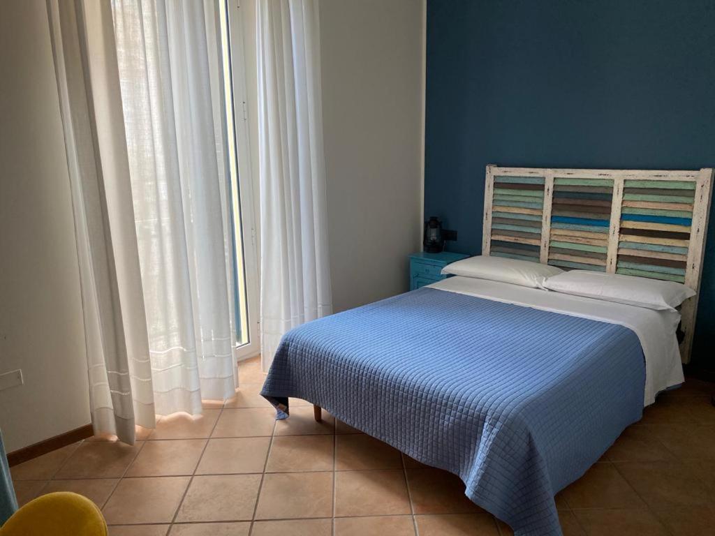 Postel nebo postele na pokoji v ubytování Camere Frangimare