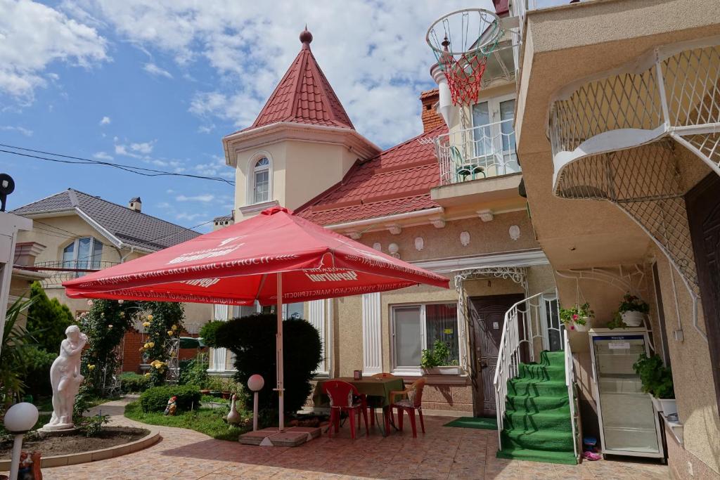 un paraguas rojo frente a una casa en White House Apartments, en Odessa