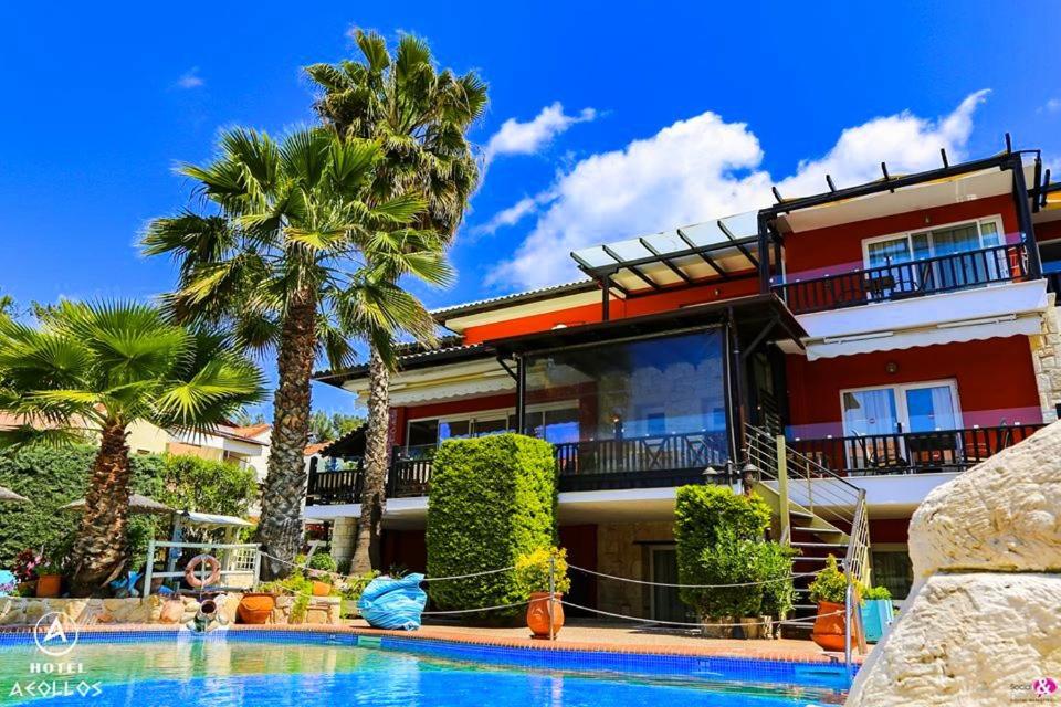 a house with a swimming pool in front of it at Hotel Aeollos in Pefkochori