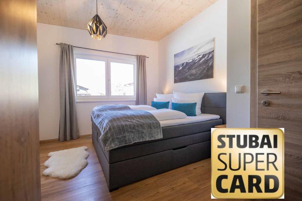 a bedroom with a bed and a sign for a stupid super card at Appartement Medraz in Fulpmes