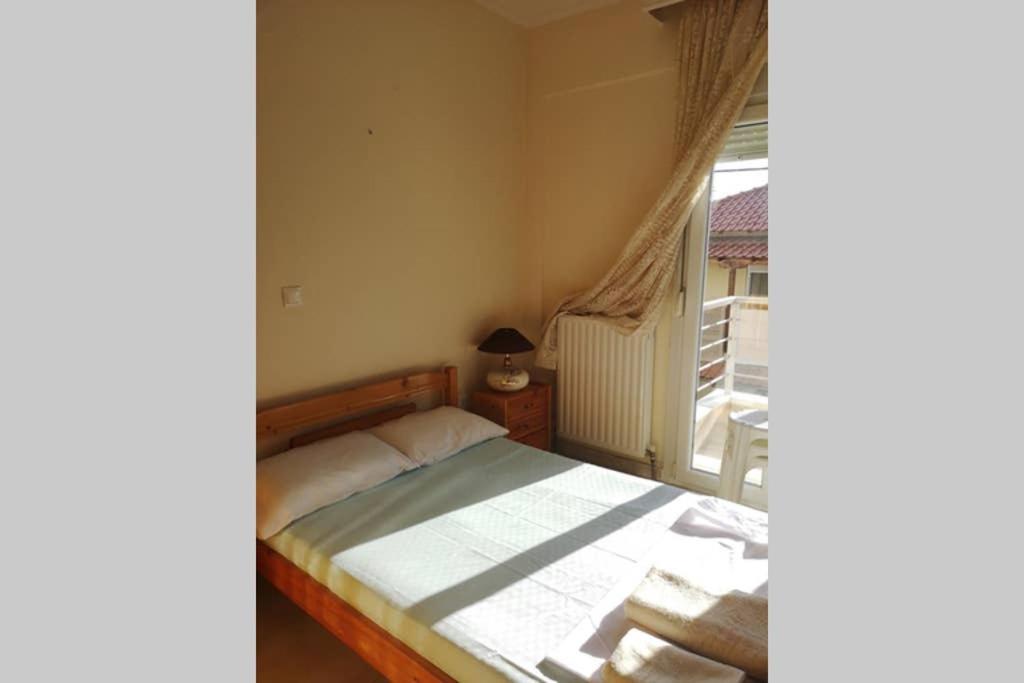 Postel nebo postele na pokoji v ubytování kallikratis apartment