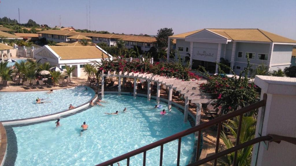 a group of people in a swimming pool at a resort at L'ácqua diRoma VaciaTemporada in Caldas Novas