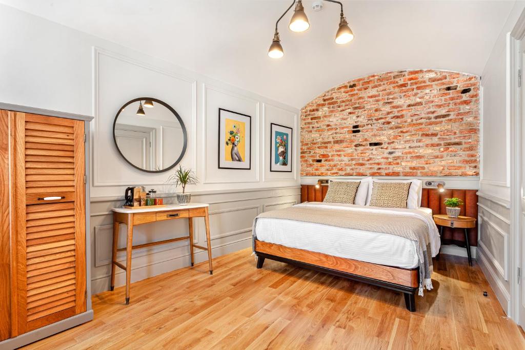 a bedroom with a bed and a brick wall at World House Boutique Hotel Galata in Istanbul