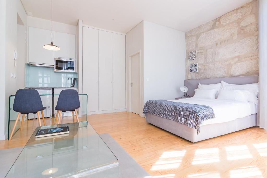 a bedroom with a bed and a glass table at Oporto Near Apartments in Porto