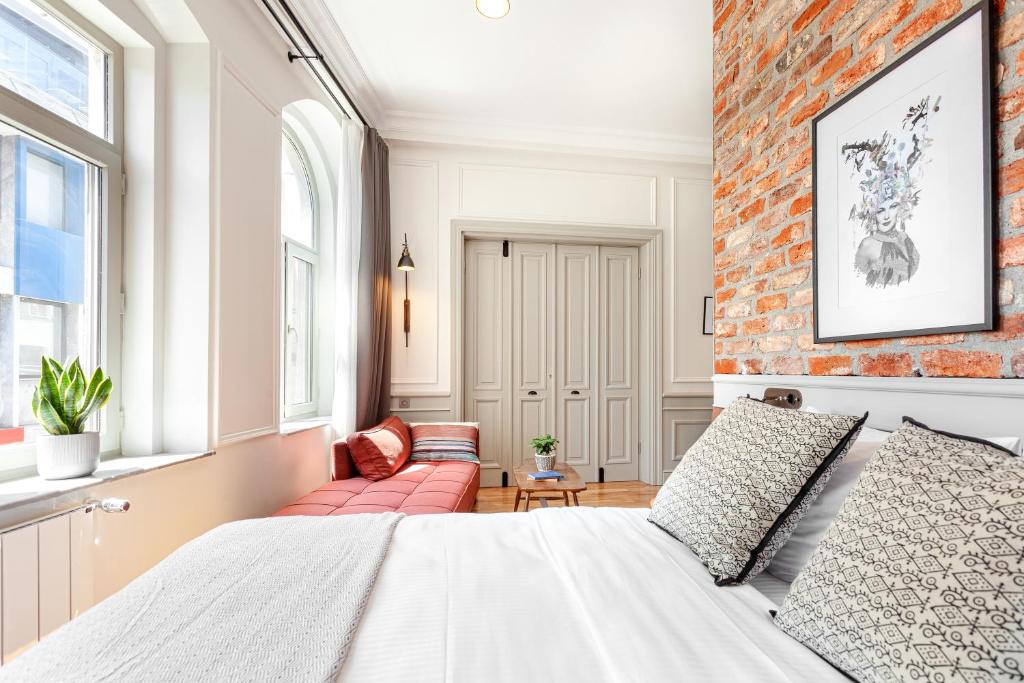 a bedroom with a bed and a brick wall at World House Boutique Hotel Galata in Istanbul