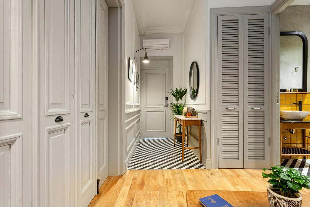 a hallway with white walls and a table and a sink at World House Boutique Hotel Galata in Istanbul