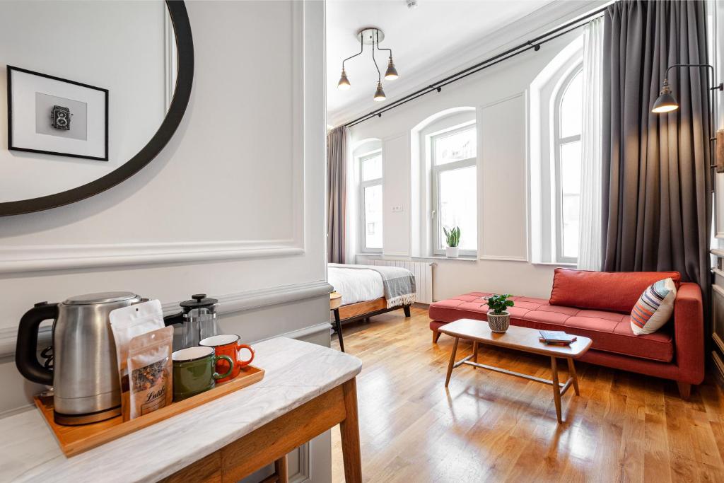 a living room with a red couch and a table at World House Boutique Hotel Galata in Istanbul