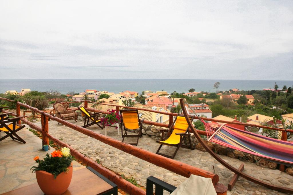 a balcony with chairs and a view of a city at Villa- nefeli in Agios Gordios