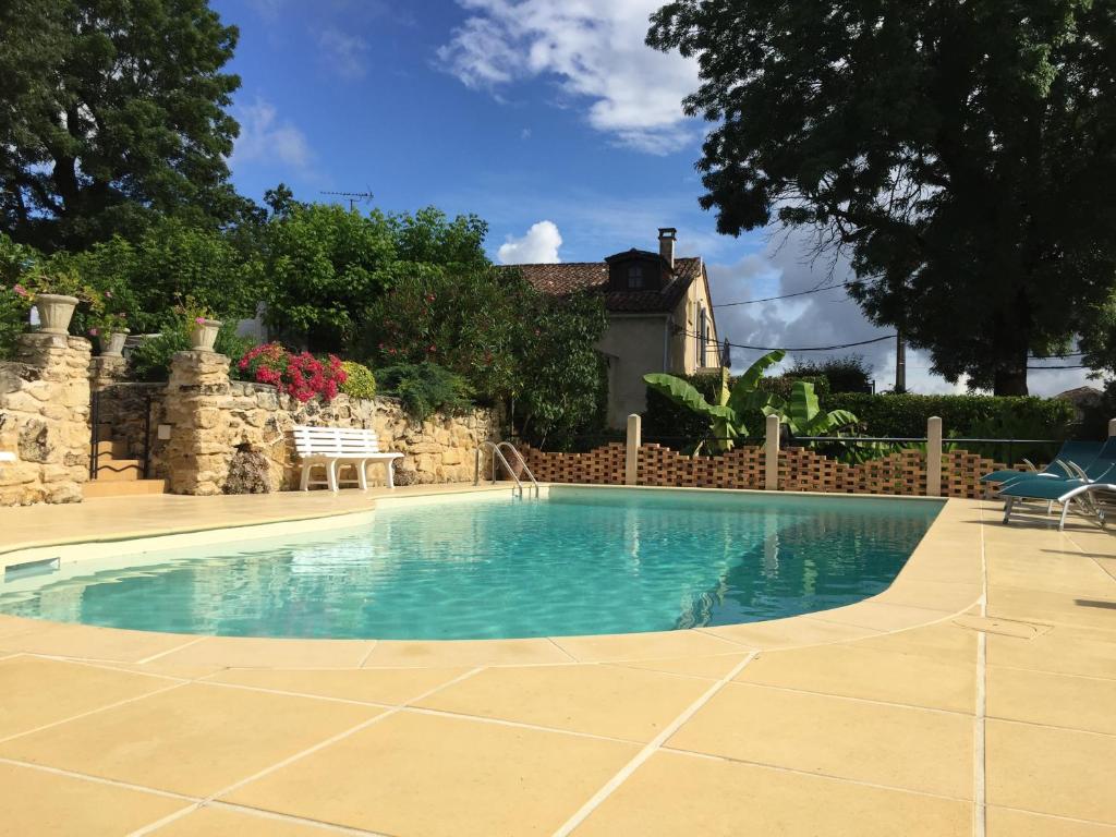 a swimming pool in front of a house at Maison calme au cœur des vignes in Sainte-Colombe